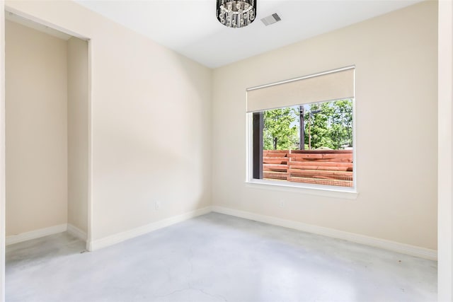 538 Magnolia Point Dr, Huffman, TX 77336 - spare room featuring concrete floors, a chandelier, and baseboards