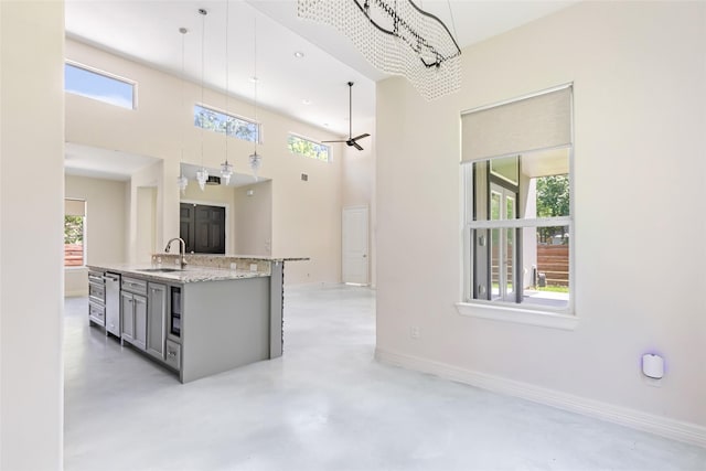 538 Magnolia Point Dr, Huffman, TX 77336 - kitchen featuring a sink, healthy amount of natural light, concrete floors, pendant lighting, and a towering ceiling