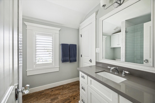446 Arlington St, Houston, TX 77007 - bathroom with lofted ceiling, vanity, baseboards, and wood finished floors