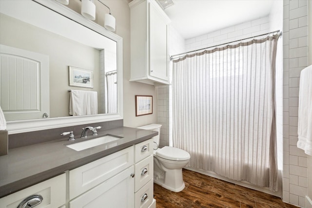446 Arlington St, Houston, TX 77007 - bathroom with vanity, toilet, wood finished floors, and shower / tub combo with curtain