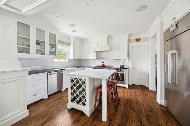 446 Arlington St, Houston, TX 77007 - kitchen with appliances with stainless steel finishes, glass insert cabinets, white cabinets, tasteful backsplash, and recessed lighting