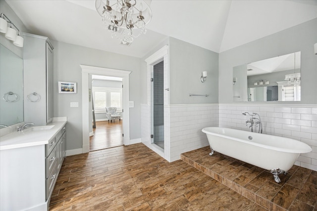 446 Arlington St, Houston, TX 77007 - full bath featuring a chandelier, a soaking tub, vanity, tile walls, and wood finished floors