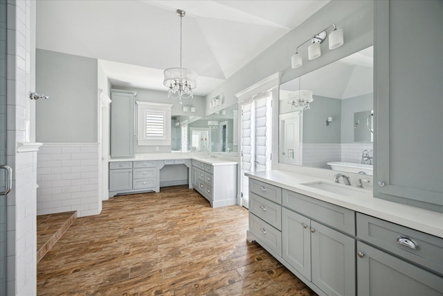 446 Arlington St, Houston, TX 77007 - full bathroom featuring a chandelier, lofted ceiling, two vanities, wood finished floors, and a stall shower
