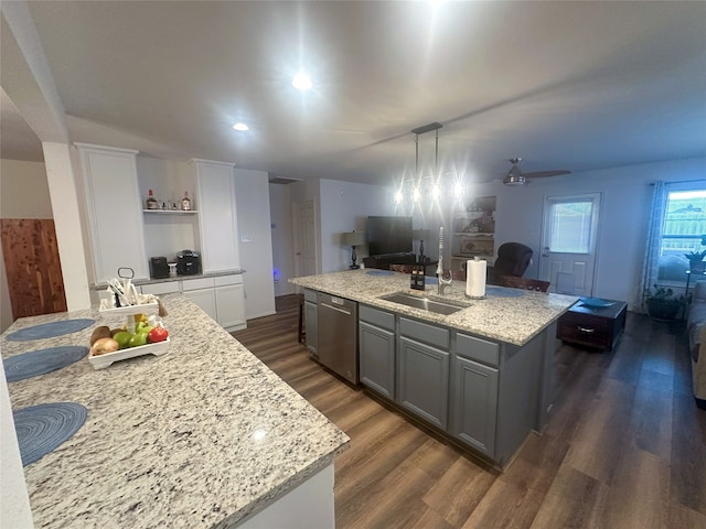 12107 English Brook Cir, Humble, TX 77346 - kitchen with dishwasher, an island with sink, gray cabinetry, dark wood-style flooring, and light stone counters