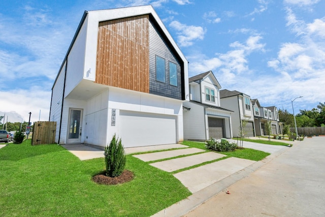 4016 Boho Ln, Houston, TX 77045 - contemporary house with an attached garage, concrete driveway, and a residential view