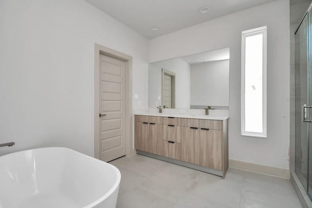 4016 Boho Ln, Houston, TX 77045 - full bath featuring double vanity, a soaking tub, a stall shower, and baseboards