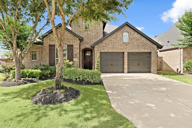 3638 Long Flower Ct, Fulshear, TX 77441 - view of front of property featuring brick siding, a garage, driveway, and a front lawn