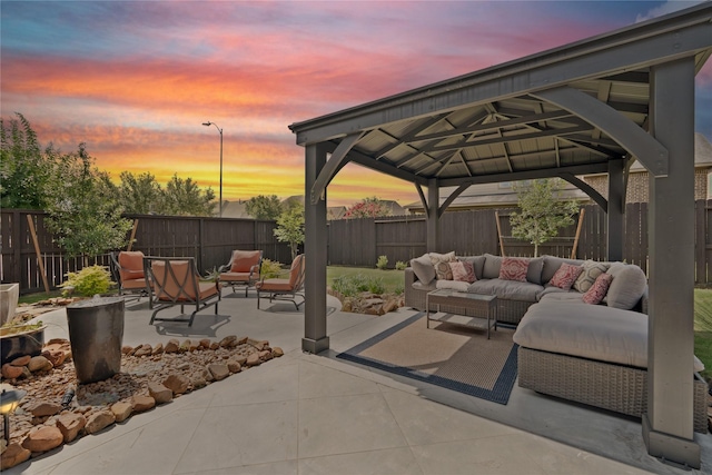 3638 Long Flower Ct, Fulshear, TX 77441 - patio terrace at dusk with an outdoor hangout area, a patio, a gazebo, and a fenced backyard