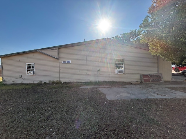 1205 14th St, Seagraves, TX 79359 - view of side of home with cooling unit and a patio