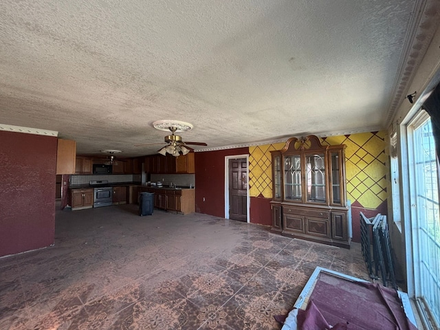 1205 14th St, Seagraves, TX 79359 - unfurnished living room with a textured ceiling and ceiling fan