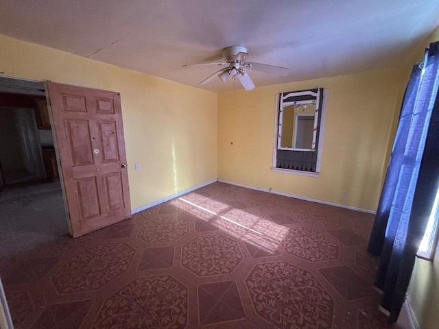 1205 14th St, Seagraves, TX 79359 - tiled spare room with a ceiling fan and baseboards
