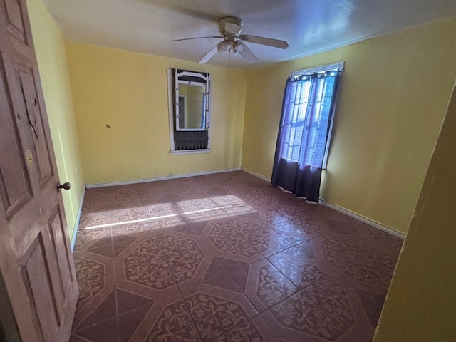 1205 14th St, Seagraves, TX 79359 - unfurnished room with a ceiling fan, baseboards, and tile patterned floors