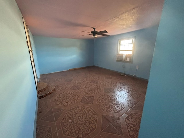 1205 14th St, Seagraves, TX 79359 - empty room featuring a ceiling fan, baseboards, and tile patterned floors