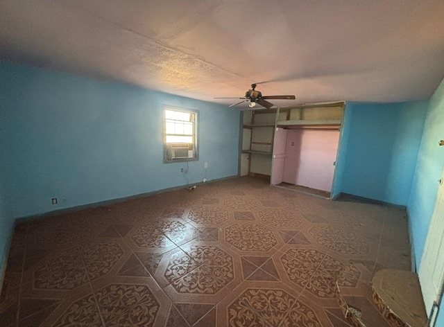 1205 14th St, Seagraves, TX 79359 - unfurnished bedroom with baseboards, light tile patterned flooring, cooling unit, and ceiling fan