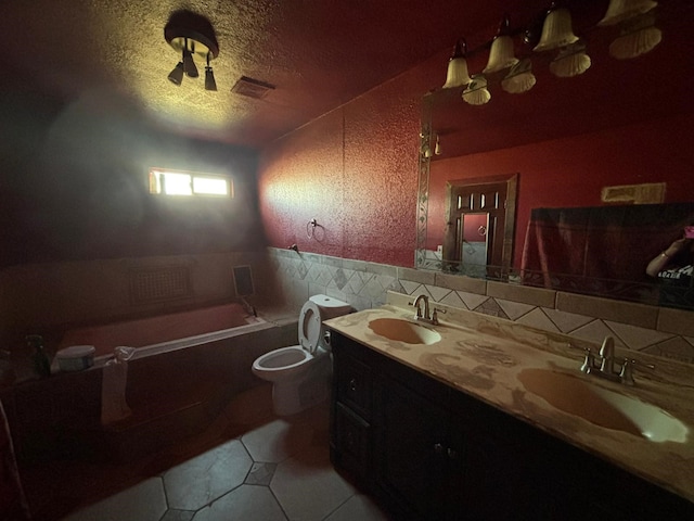 1205 14th St, Seagraves, TX 79359 - full bathroom featuring tile patterned flooring, a bath, a textured ceiling, toilet, and double vanity
