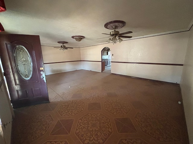 1205 14th St, Seagraves, TX 79359 - tiled entrance foyer with a ceiling fan and arched walkways