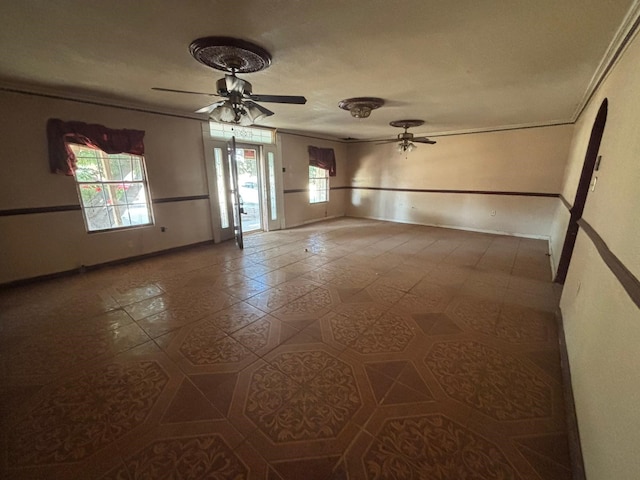 1205 14th St, Seagraves, TX 79359 - tiled empty room featuring ceiling fan, crown molding, and baseboards