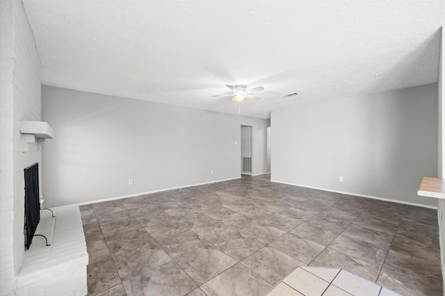 9918 Enchanted Stone Dr, Houston, TX 77070 - unfurnished living room featuring ceiling fan, a fireplace, a textured ceiling, and baseboards