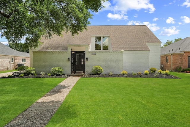 1323 Warwickshire Dr, Houston, TX 77077 - view of front of home with a front lawn, brick siding, and roof with shingles