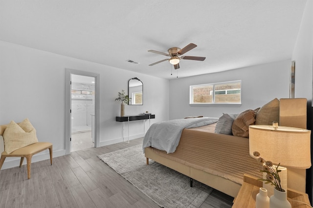 1323 Warwickshire Dr, Houston, TX 77077 - bedroom featuring wood finished floors, a ceiling fan, ensuite bathroom, and baseboards
