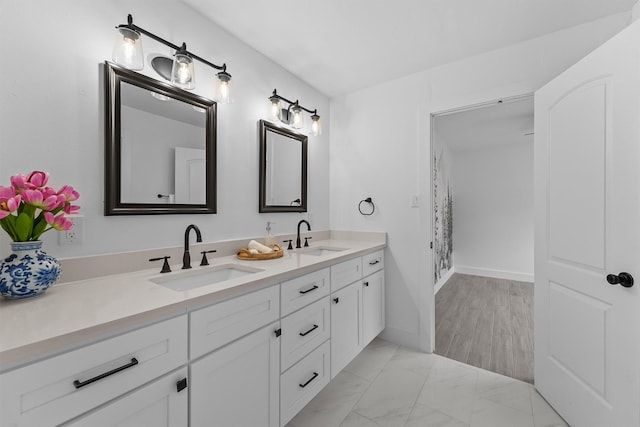 1323 Warwickshire Dr, Houston, TX 77077 - full bathroom featuring double vanity and marble look tile flooring