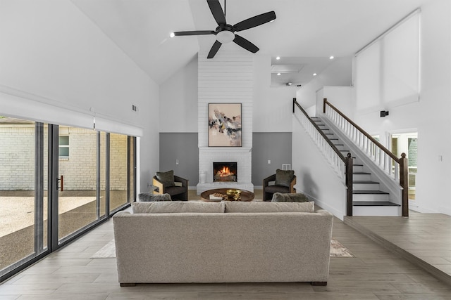 1323 Warwickshire Dr, Houston, TX 77077 - living room featuring high vaulted ceiling, a fireplace, ceiling fan, stairs, and baseboards