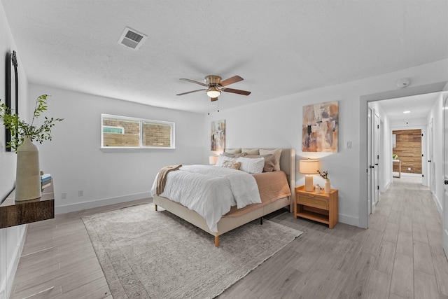 1323 Warwickshire Dr, Houston, TX 77077 - bedroom featuring baseboards, light wood finished floors, and ceiling fan