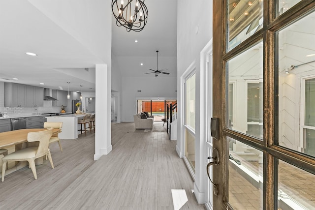 1323 Warwickshire Dr, Houston, TX 77077 - entryway featuring a chandelier, recessed lighting, a high ceiling, light wood-type flooring, and a ceiling fan