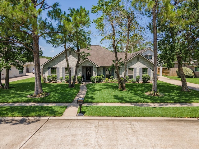 811 Hackberry Ln, Friendswood, TX 77546 - view of front of house featuring a front lawn and stone siding