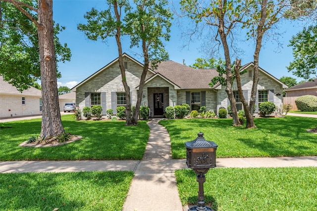 811 Hackberry Ln, Friendswood, TX 77546 - ranch-style home with a front lawn and stone siding