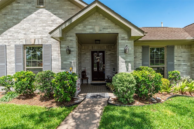 811 Hackberry Ln, Friendswood, TX 77546 - view of exterior entry with a shingled roof and brick siding