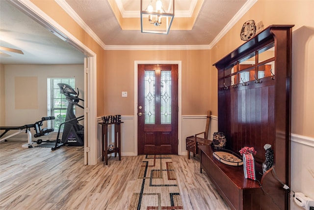 811 Hackberry Ln, Friendswood, TX 77546 - entryway with wood finished floors, a tray ceiling, a chandelier, wainscoting, and crown molding