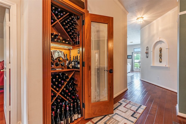 811 Hackberry Ln, Friendswood, TX 77546 - wine cellar featuring ornamental molding, wood finished floors, and baseboards