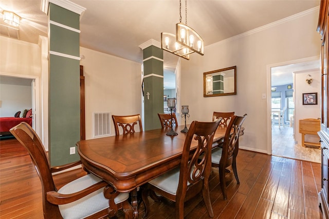 811 Hackberry Ln, Friendswood, TX 77546 - dining room with crown molding, dark wood-type flooring, a chandelier, and baseboards