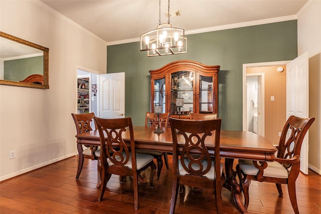 811 Hackberry Ln, Friendswood, TX 77546 - dining space with dark wood-type flooring, a chandelier, ornamental molding, and baseboards