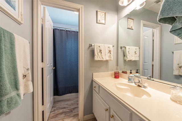 811 Hackberry Ln, Friendswood, TX 77546 - full bath with vanity, wood finished floors, and a shower with curtain