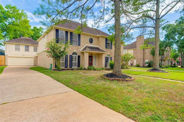 14823 Atterbury Dr, Sugar Land, TX 77498 - colonial-style house featuring an attached garage, brick siding, concrete driveway, and a front lawn