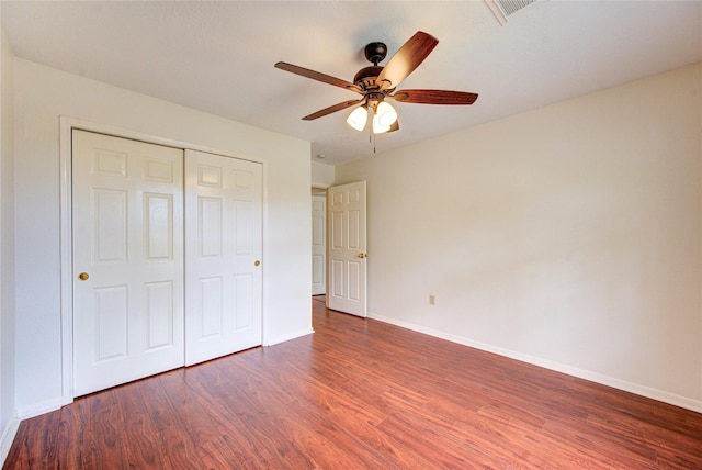 14823 Atterbury Dr, Sugar Land, TX 77498 - unfurnished bedroom featuring wood finished floors, baseboards, a closet, and ceiling fan