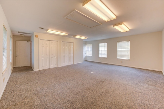 14823 Atterbury Dr, Sugar Land, TX 77498 - unfurnished bedroom featuring attic access, two closets, and baseboards