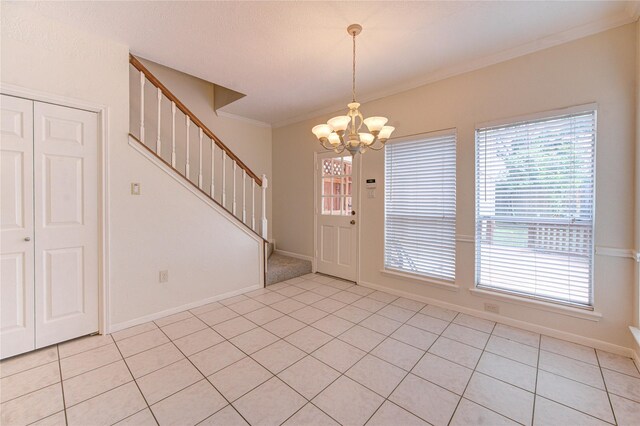 14823 Atterbury Dr, Sugar Land, TX 77498 - entrance foyer featuring stairway, a chandelier, light tile patterned floors, healthy amount of natural light, and ornamental molding