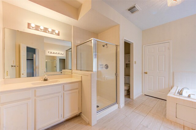 14823 Atterbury Dr, Sugar Land, TX 77498 - full bath featuring toilet, a stall shower, vanity, a bath, and baseboards