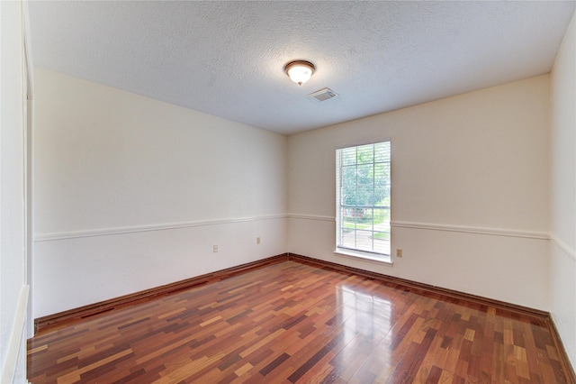 14823 Atterbury Dr, Sugar Land, TX 77498 - spare room with wood finished floors, baseboards, and a textured ceiling