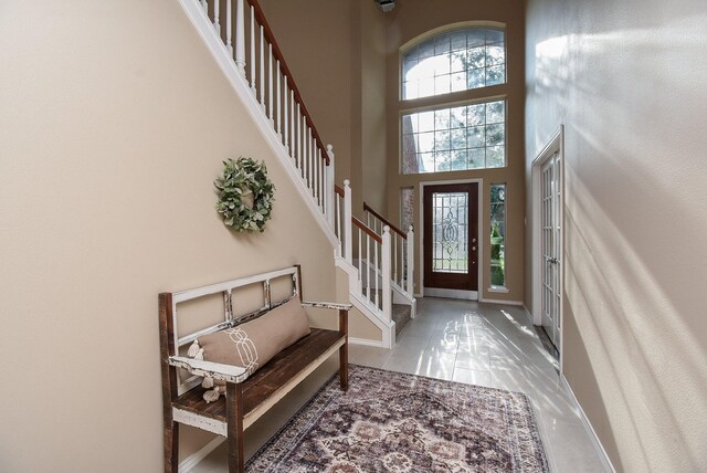 2803 Lakecrest Way Dr, Katy, TX 77493 - entrance foyer with plenty of natural light, stairs, baseboards, a towering ceiling, and tile patterned floors