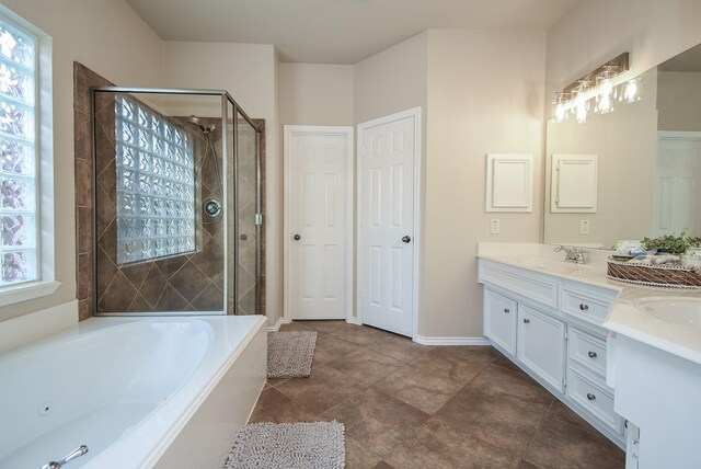 2803 Lakecrest Way Dr, Katy, TX 77493 - bathroom with double vanity, a tub with jets, a stall shower, and baseboards