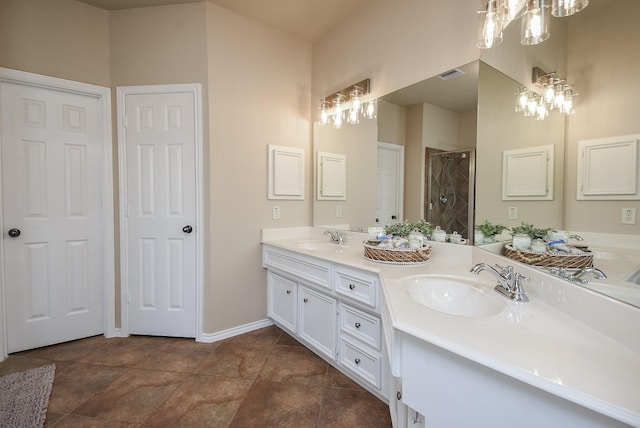 2803 Lakecrest Way Dr, Katy, TX 77493 - bathroom featuring double vanity, a tile shower, a chandelier, and baseboards
