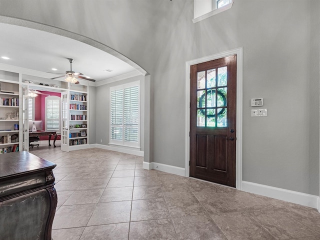 12118 Pinelands Park Ln, Humble, TX 77346 - tiled foyer entrance with plenty of natural light, crown molding, ceiling fan, arched walkways, and recessed lighting