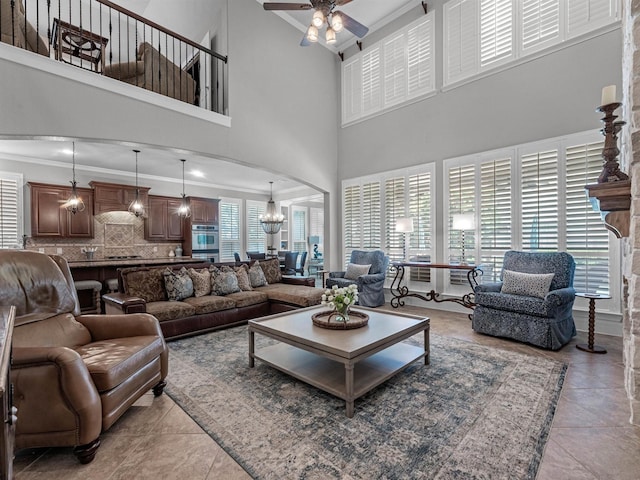 12118 Pinelands Park Ln, Humble, TX 77346 - living room with crown molding, a high ceiling, arched walkways, ceiling fan, and light tile patterned floors