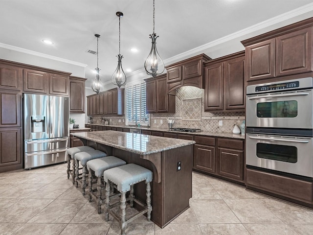 12118 Pinelands Park Ln, Humble, TX 77346 - kitchen featuring stainless steel appliances, crown molding, a center island, decorative backsplash, and dark brown cabinets