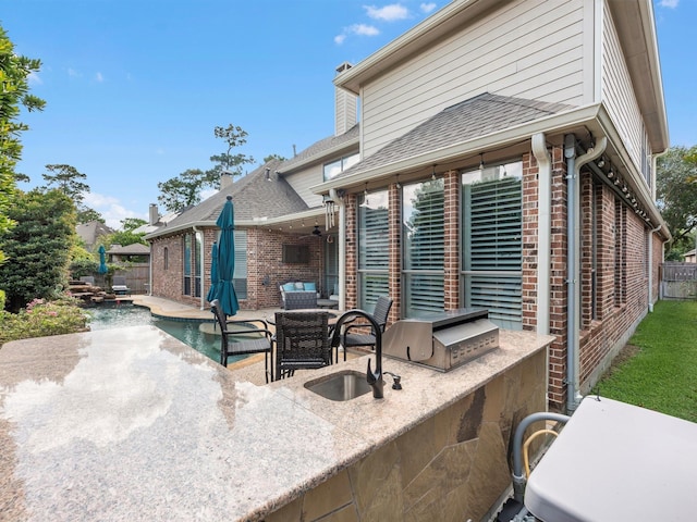 12118 Pinelands Park Ln, Humble, TX 77346 - view of patio with exterior kitchen and a ceiling fan
