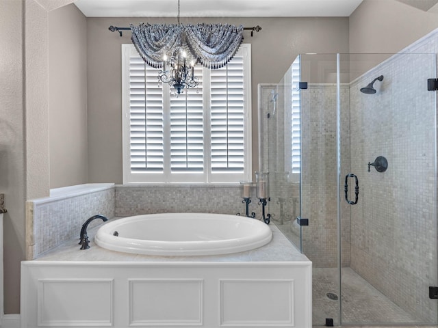 12118 Pinelands Park Ln, Humble, TX 77346 - full bathroom with a garden tub, a shower stall, and a chandelier